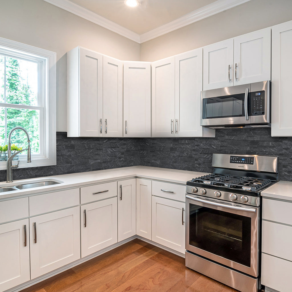 An image of dark grey colored Shadow Grey peel and stick self-adhesive real stone wall tiles from stoneflex stuck on to a kitchen backsplash.